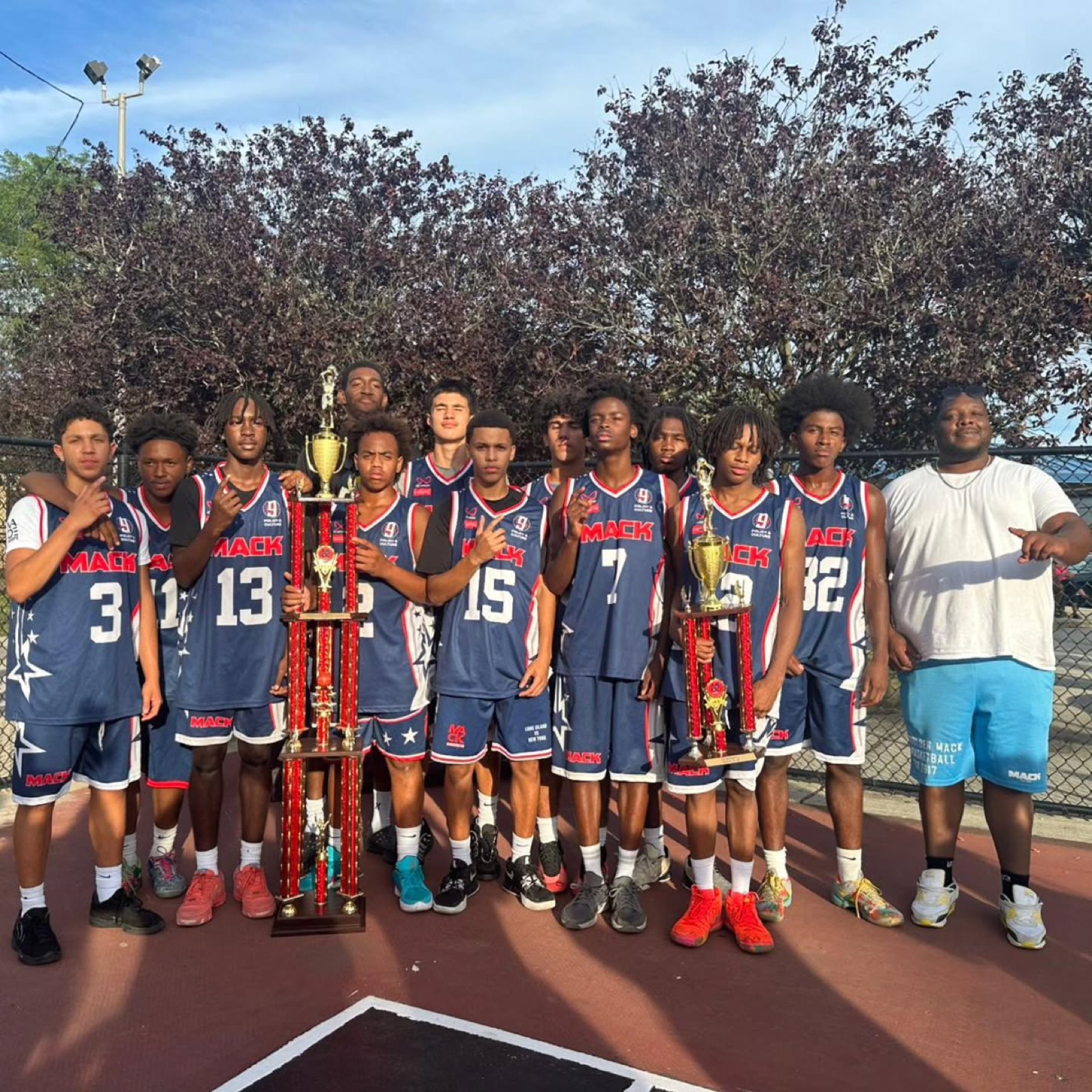 Aviation Athletics team celebrating a championship with trophies at The Mack summer league