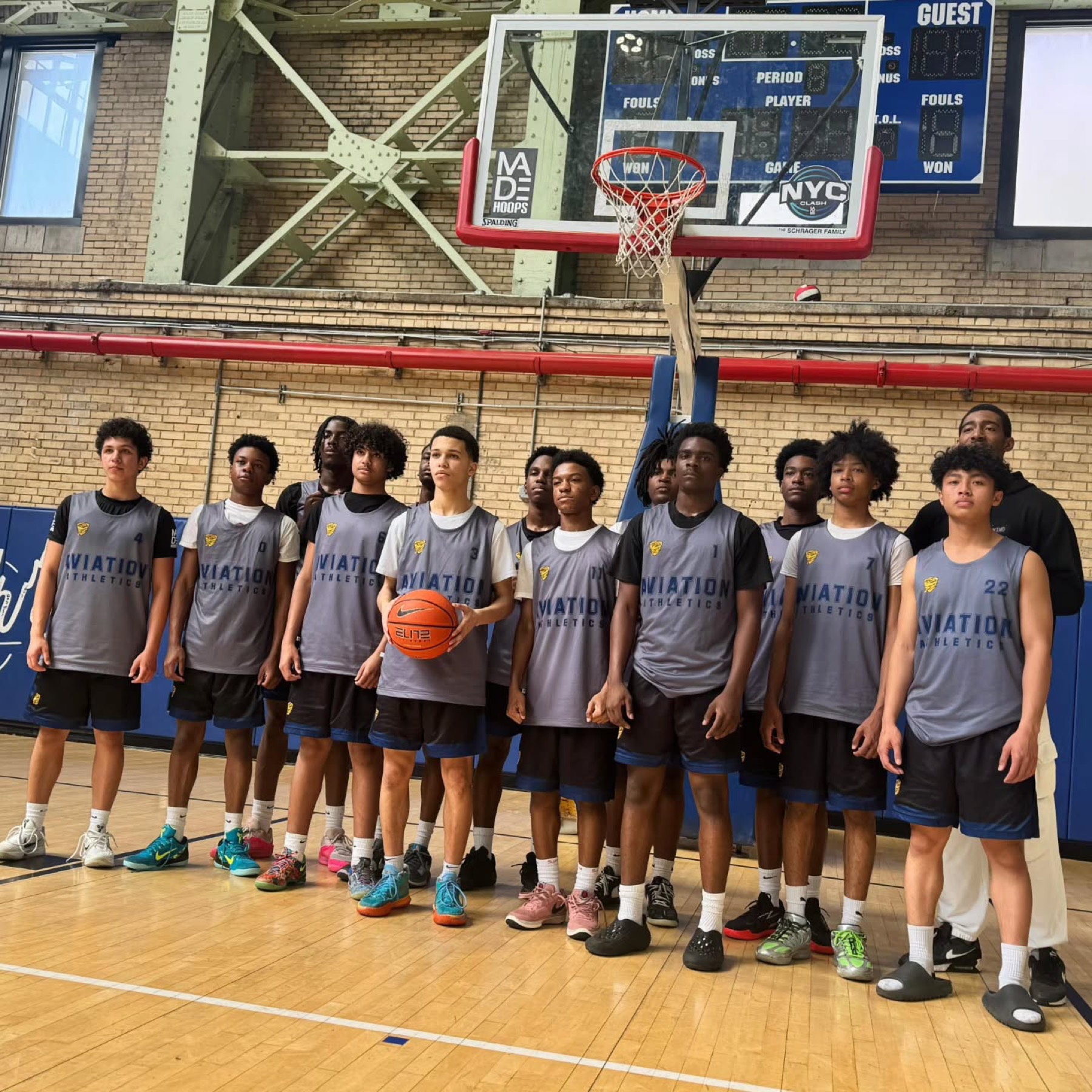 Aviation Athletics team lined up on the court at a MadeHoops event